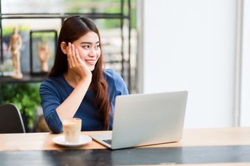 Asian business girl working and drinking coffee in cafe