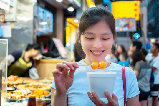 Asian Young Female Eating Famous Street Food - Fish Ball, In Hong Kong