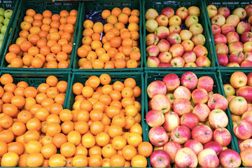 Oranges, tangerines and apples for sale at a market
