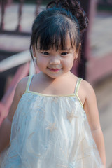 Happy little girl in autumn park. Fashion portrait Kid outdoor.