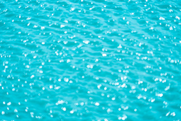 Abstract bokeh from light in the blue water