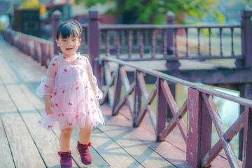 Naklejka premium portrait of a girl. Happy little girl in autumn park. Fashion Kid outdoor.
