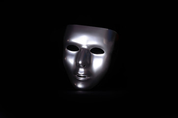 shiny metal mask on black background