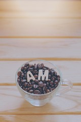 Fototapeta na wymiar concept alphabet AM on coffee beans.Means coffee time