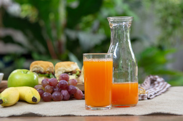 Orange juice with breakfast on the table