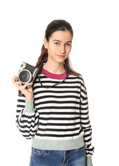 Young girl with photo camera on white background