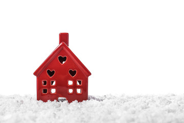 Figure of house on snow against white background