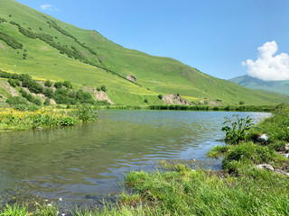 Fototapeta na wymiar Midagrabinskoye lake in the mountains of North Ossetia in summer