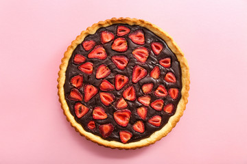 Tasty chocolate cake with strawberry on color background