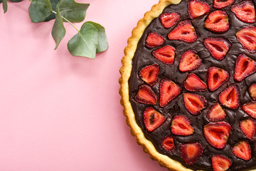Tasty chocolate cake with strawberry on color background
