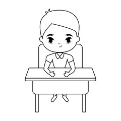 little student boy sitting in school desk