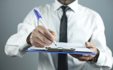Businessman writing on empty paper. Business concept
