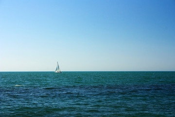 Lonely sail to the sea on the horizon