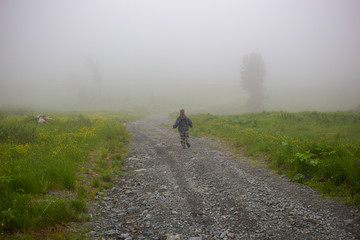 Boy on road in fog