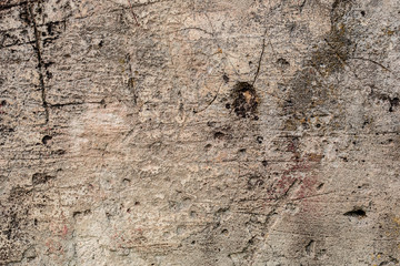 Texture of a concrete wall with cracks and scratches which can be used as a background