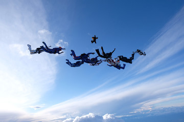 Naklejka na ściany i meble A group of skydivers is in the sky.