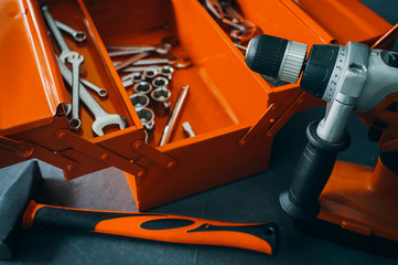 Mechanic workshop. Open professional toolbox. Closeup of wrench instruments, drill and hammer.