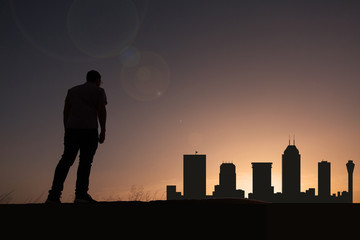 Traveler in front of Indianapolis city skyline