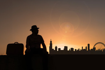 Traveler with suitcase and hat in front of city skyline of chicago in united states