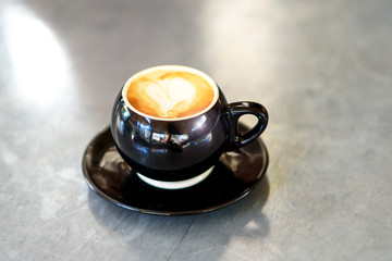 Coffee latte on table with morning nature light.