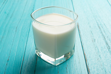 cup of milk on blue table