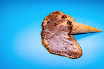 coffee flavor ice cream cone melted on a blue background