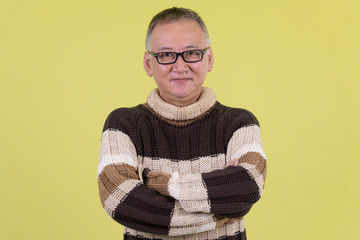 Mature Japanese man with arms crossed ready for winter