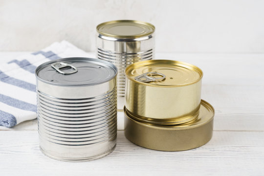 Various closed tin cans with food preserves.