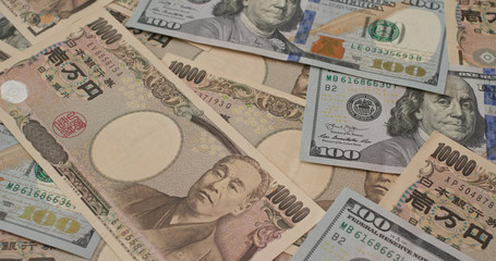 Stack of American USD and Japanese Yen