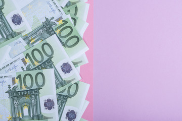 Euro cash on a lilac, purple and pink background. Euro Money Banknotes. Euro Money. Euro bill. Place for text.