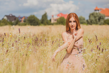 Freedom concept, elegant woman in long beige romantic dress at the field 