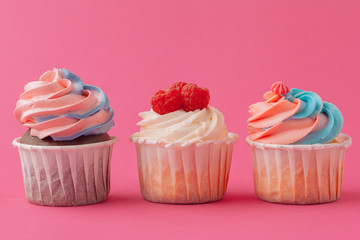 Yummy sweet cupcakes on light pink background