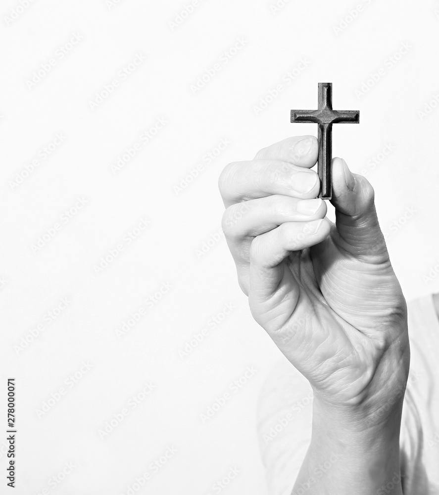 Wall mural hand holding a cross  stock image on white background stock photo