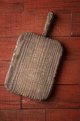 Old cutting board on wooden table. Food background