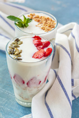 Granola with yogurt and berries for healthy breakfast on a table