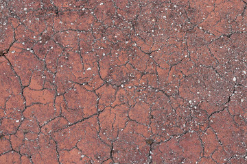 Concrete background in cracks of brown color