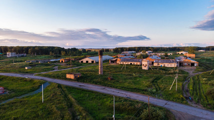 Aerial shot. The road passing by an abandoned farm in the village