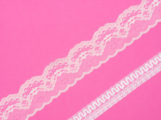 White lace on pink background