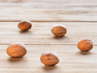 Nutmeg (Myristica fragrans) on brown wooden background