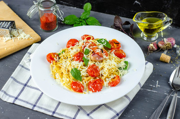 Fresh pasta with garlic Cherry Tomatoes and basil. Delicious Pasta Plate. Spaghetti. Italian food. Italy. Roma. Fine dining. Healthy food. Vegetarian. Healthy food