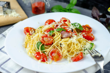 Fresh pasta with garlic Cherry Tomatoes and basil. Delicious Pasta Plate. Spaghetti. Italian food. Italy. Roma. Fine dining. Healthy food. Vegetarian. Healthy food