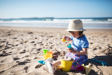 toddler girl plaiying at summer sand beach,Northern Ireland