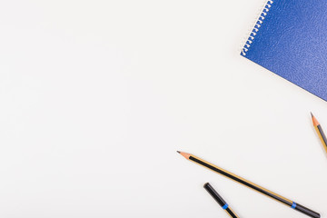 Notepad and pencils on left