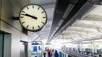 Clock with crowded passengers at the MRT station