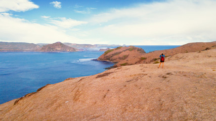 Female tourist standing on Padar island hill