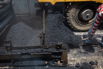 Construction work for a road and highway repair,Concept: Transportation symbol for vehicle safety,Worker operating asphalt road city