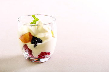 Berry and cream dessert in a glass
