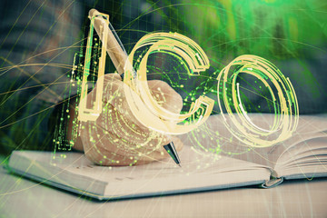 Cryptocurrency hologram over woman's hands writing background. Concept of blockchain. Double...