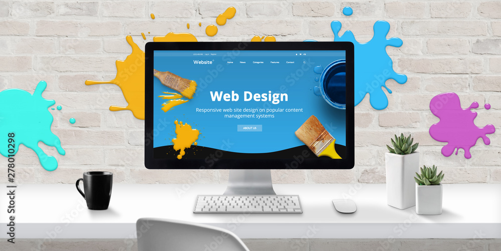 Fototapete Web design studio with modern web site theme on computer display with color drops on brick wall. Concept of creating modern and colorful web sites.