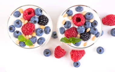 Two glasses of white yogurt with wild berries